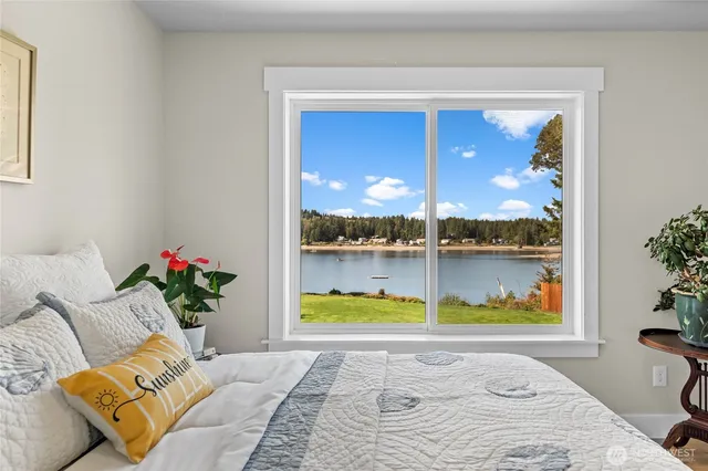 a bathroom with a sink toilet a mirror and shower curtain