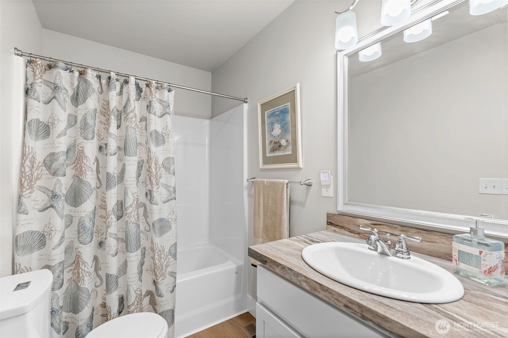 460 East Stretch Island Road South Grapeview, WA 98546 - Photo 24 of 39 a bathroom with a sink toilet a mirror and shower curtain