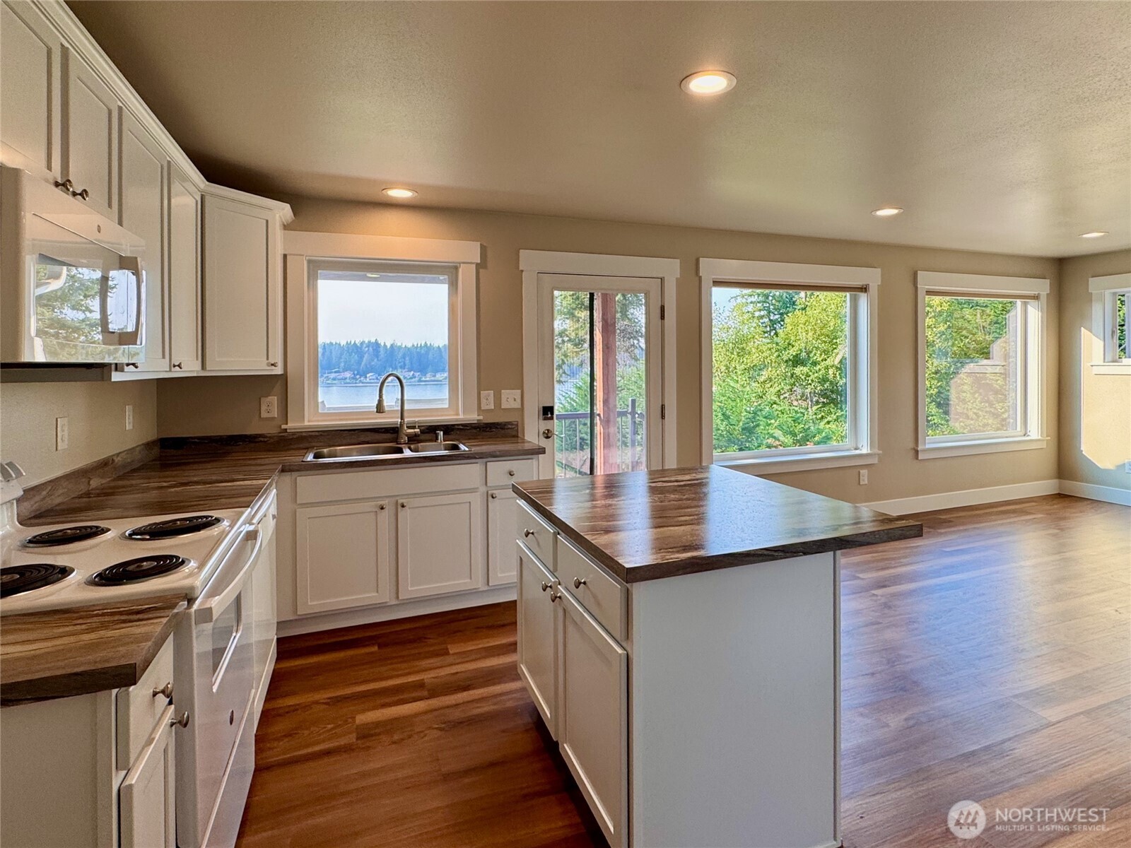460 East Stretch Island Road South Grapeview, WA 98546 - Photo 25 of 39 a kitchen with granite countertop a stove and a sink