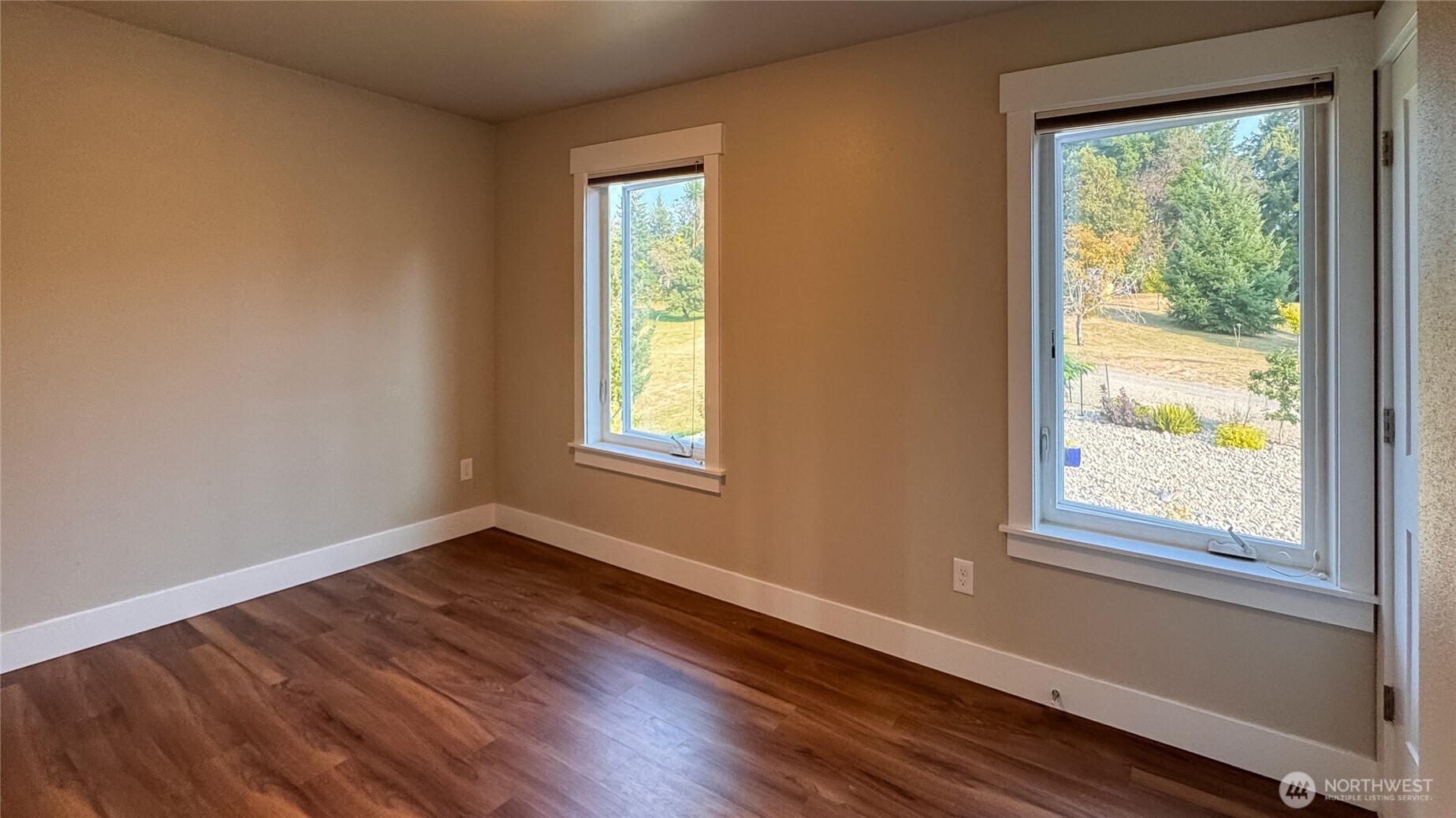 460 East Stretch Island Road South Grapeview, WA 98546 - Photo 27 of 39 a view of an empty room with wooden floor and a window