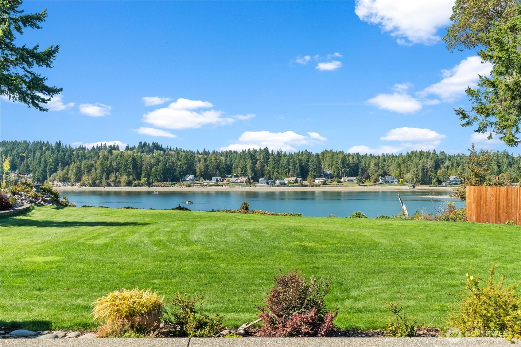 460 East Stretch Island Road South Grapeview, WA 98546 - Photo 29 of 39 a view of a lake with a house in the background