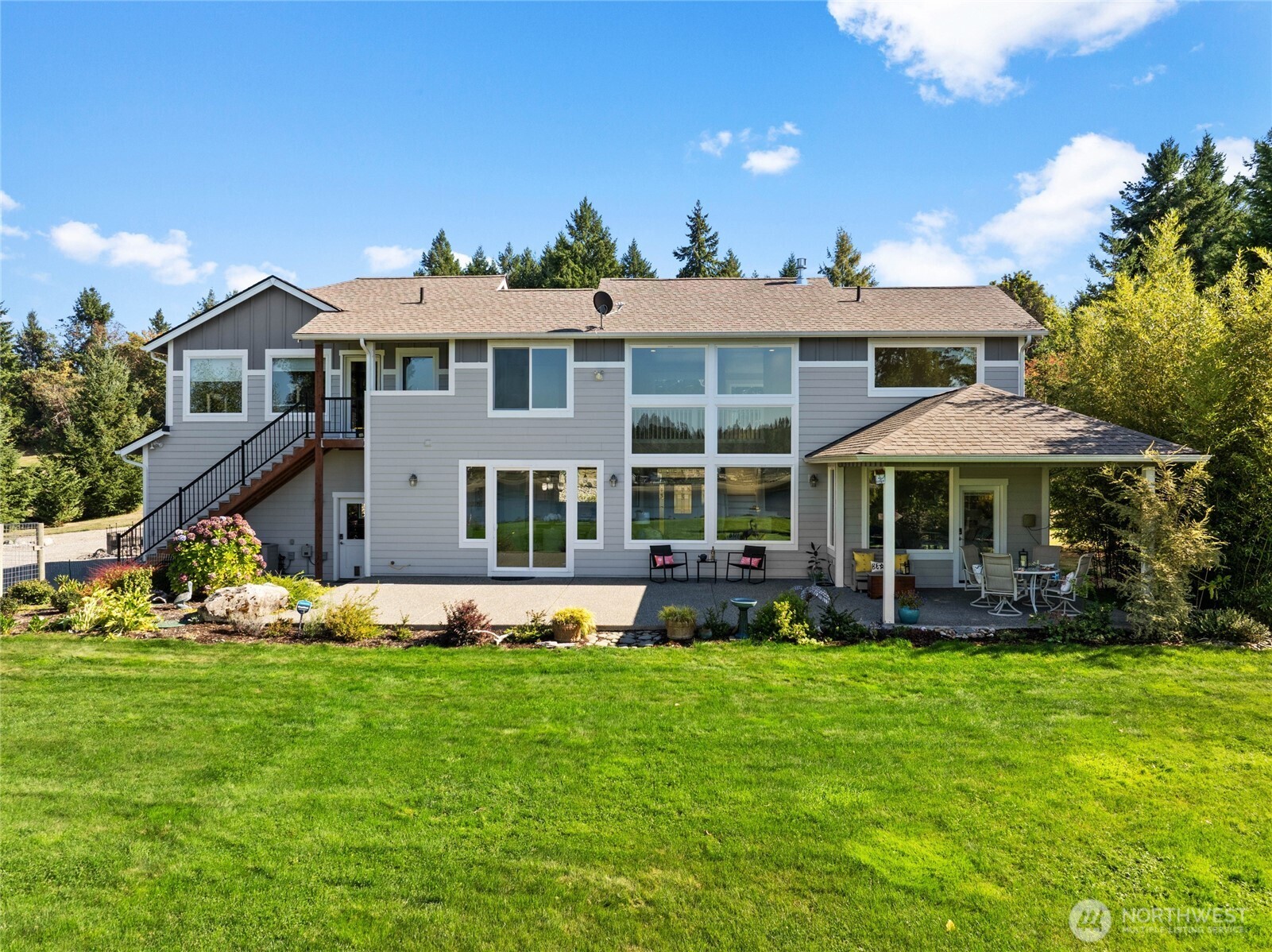 460 East Stretch Island Road South Grapeview, WA 98546 - Photo 30 of 39 a front view of a house with garden