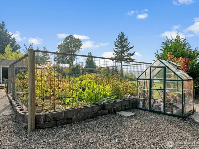 an aerial view of a residential houses with lake and city view