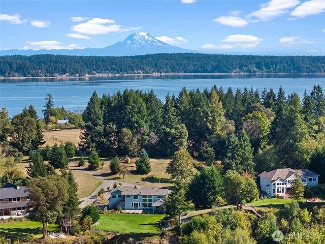 an aerial view of house with yard swimming pool and lake view