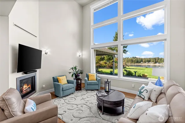 a living room with furniture tv and a large window