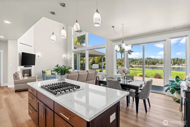 a large kitchen with a table chairs and flat screen tv