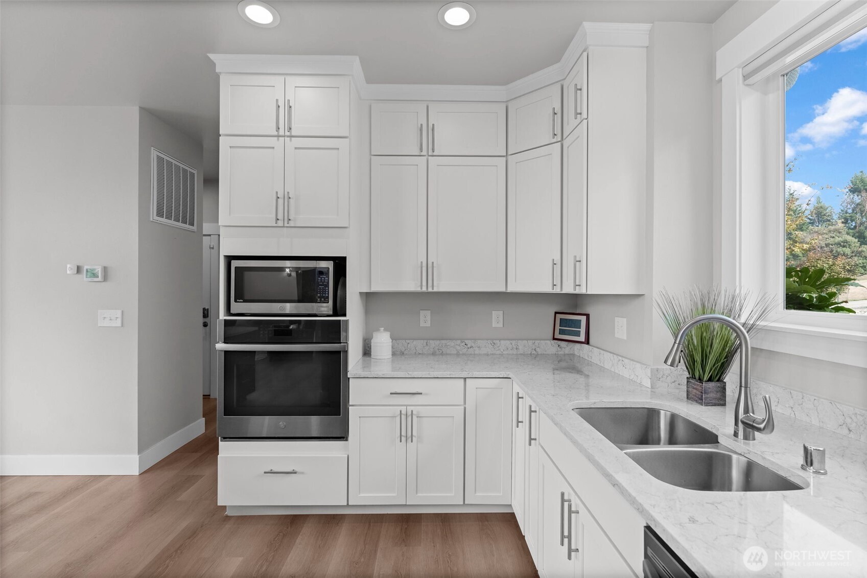 460 East Stretch Island Road South Grapeview, WA 98546 - Photo 10 of 39 a kitchen with granite countertop white cabinets and stainless steel appliances