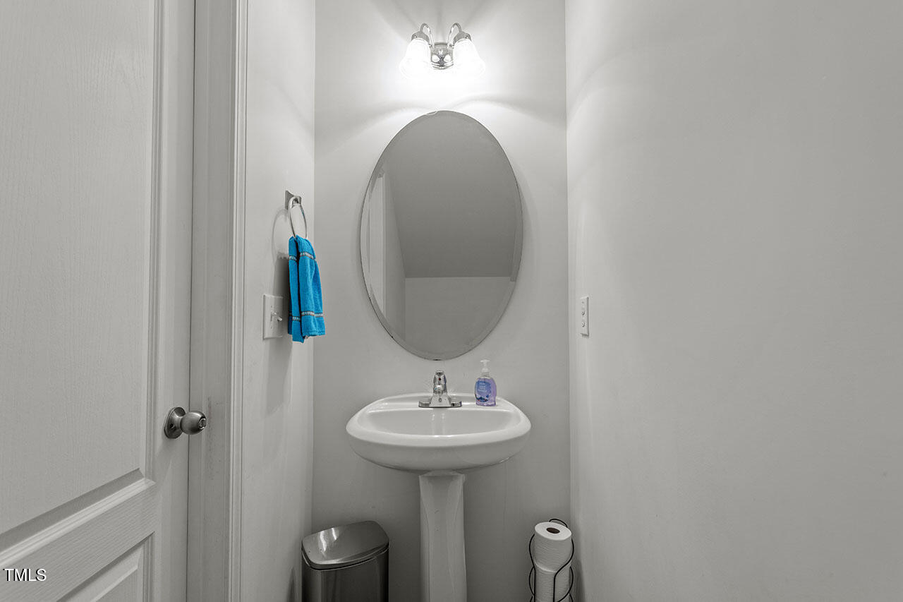 4817 Kitledge Drive Raleigh, NC 27610 - Photo 15 of 28 a bathroom with a sink and a mirror