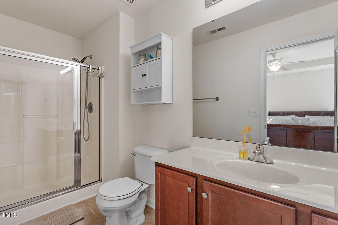 4817 Kitledge Drive Raleigh, NC 27610 - Photo 18 of 28 a bathroom with a granite countertop sink toilet and shower