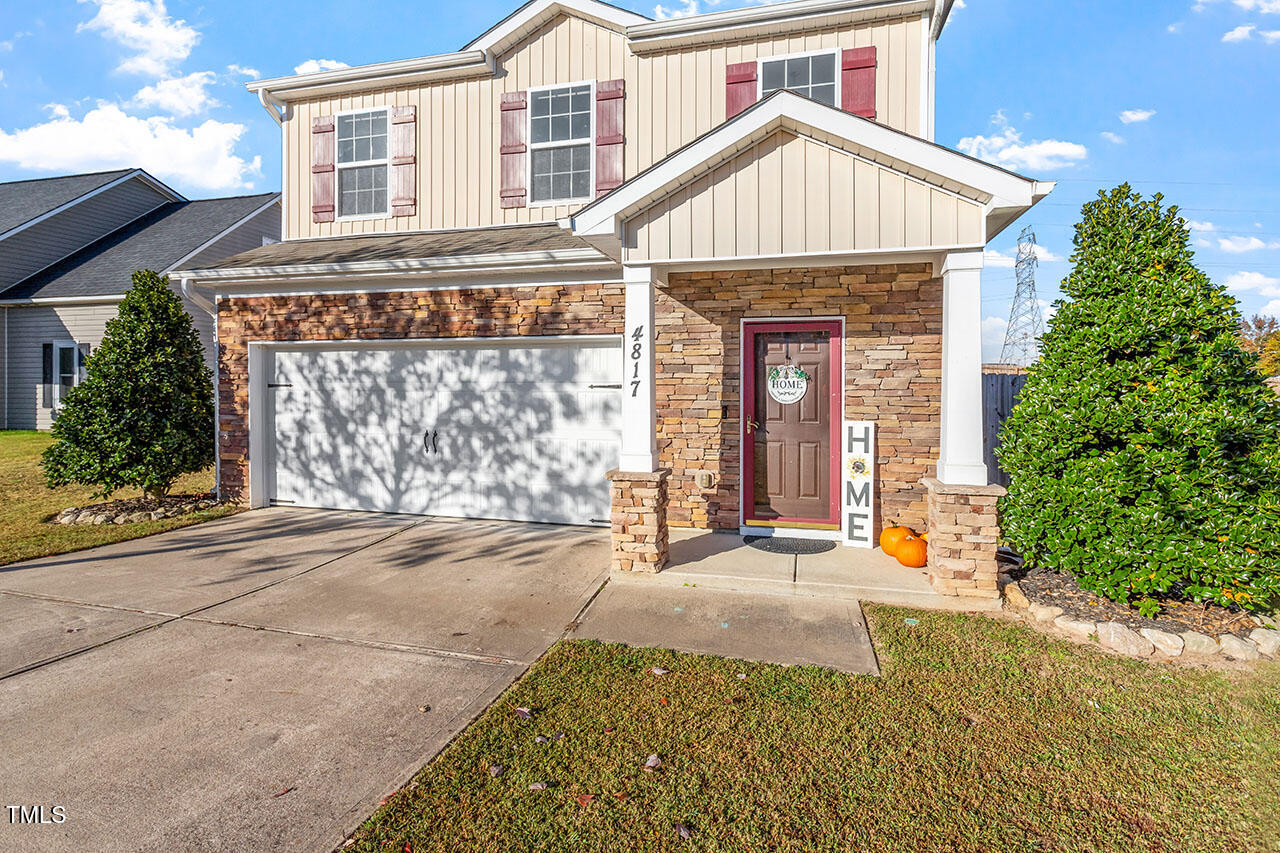 4817 Kitledge Drive Raleigh, NC 27610 - Photo 2 of 28 a front view of a house with a yard and garage