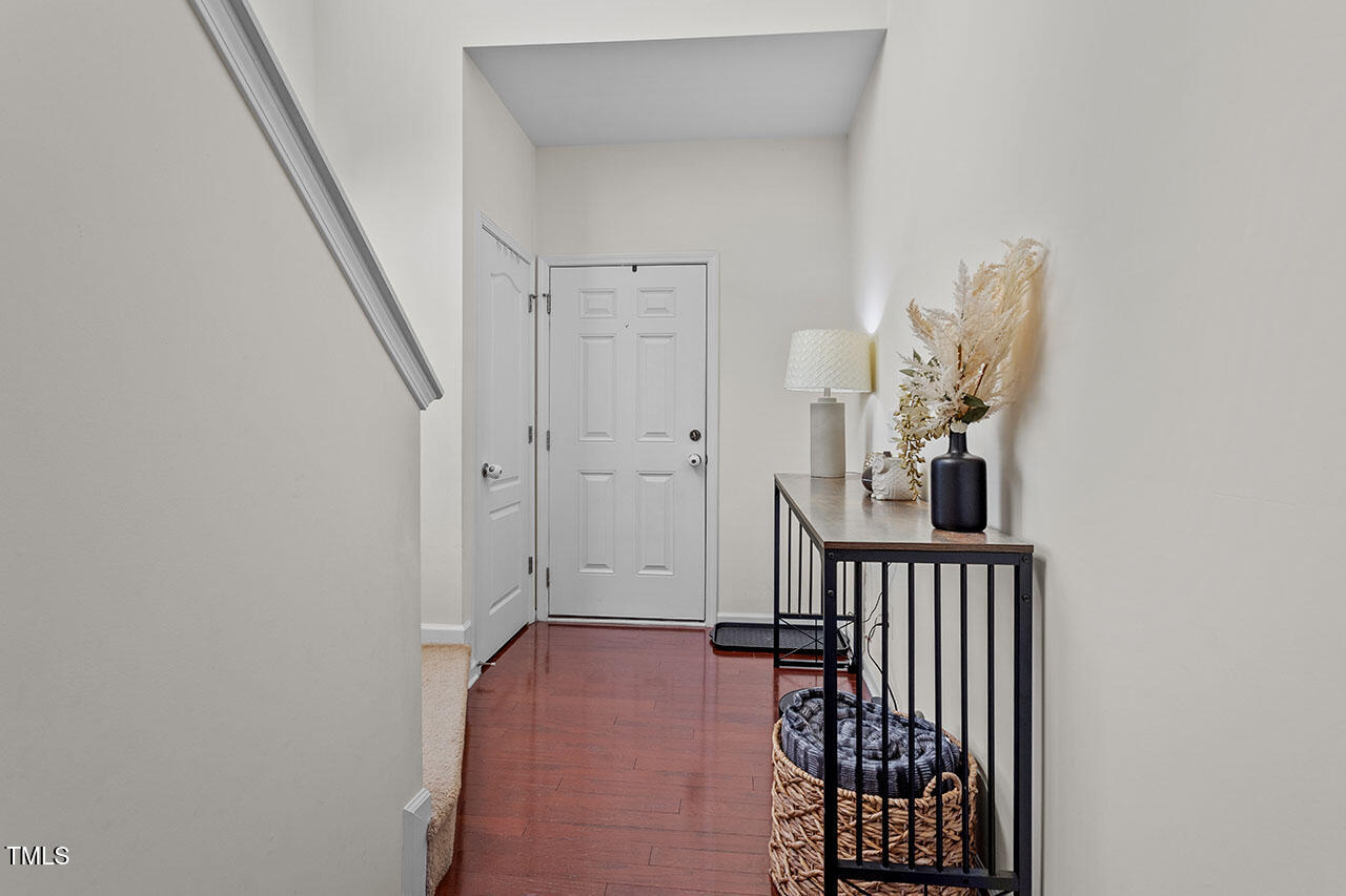4817 Kitledge Drive Raleigh, NC 27610 - Photo 3 of 28 a view of a hallway with wooden floor and entryway