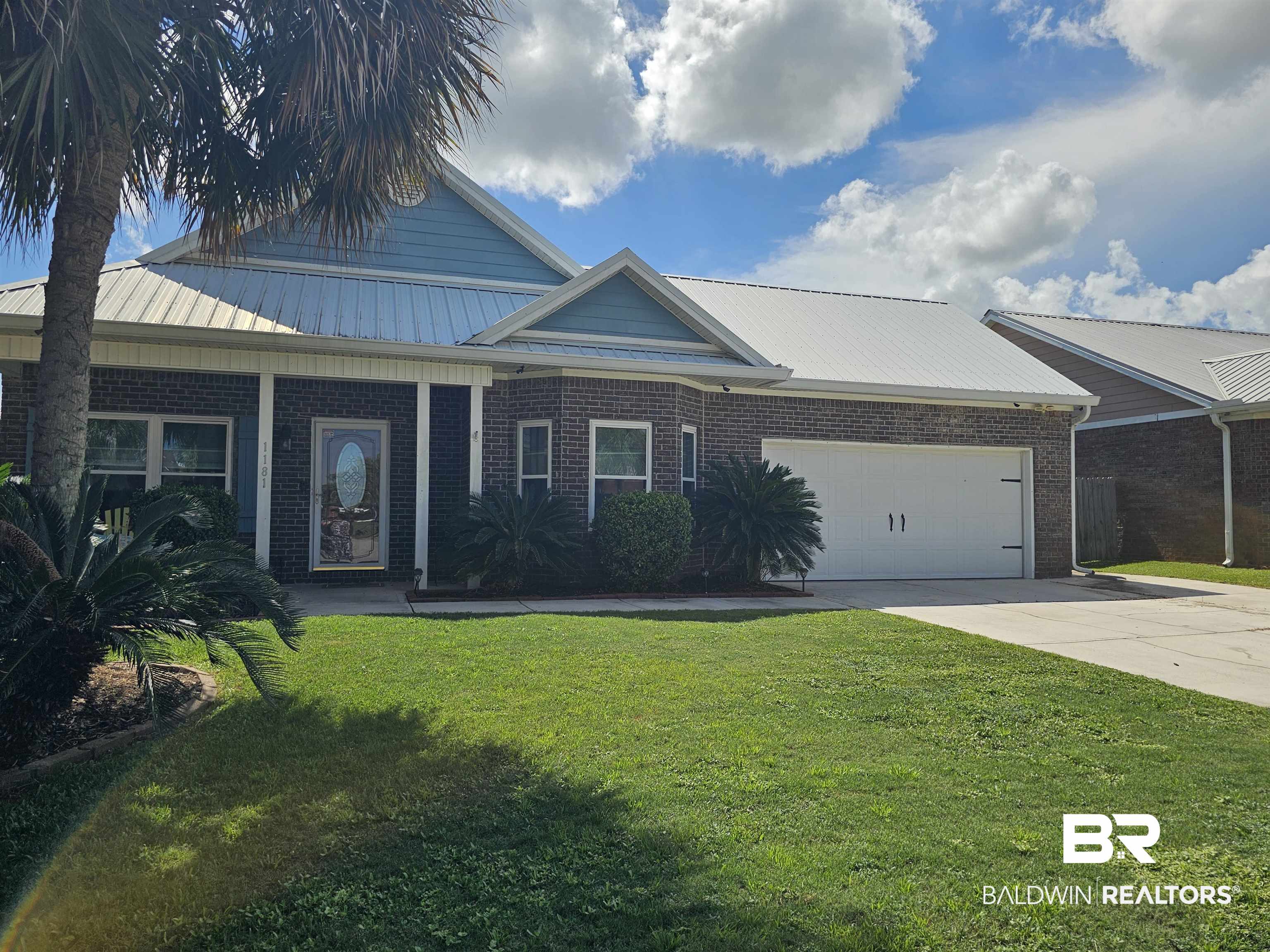 1181 Sloane Cove Foley, AL 36535 - Photo 10 of 10 Brick exterior featuring a light blue siding accent and a metal roof