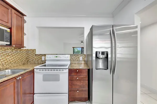 a kitchen with stainless steel appliances granite countertop a stove and a microwave