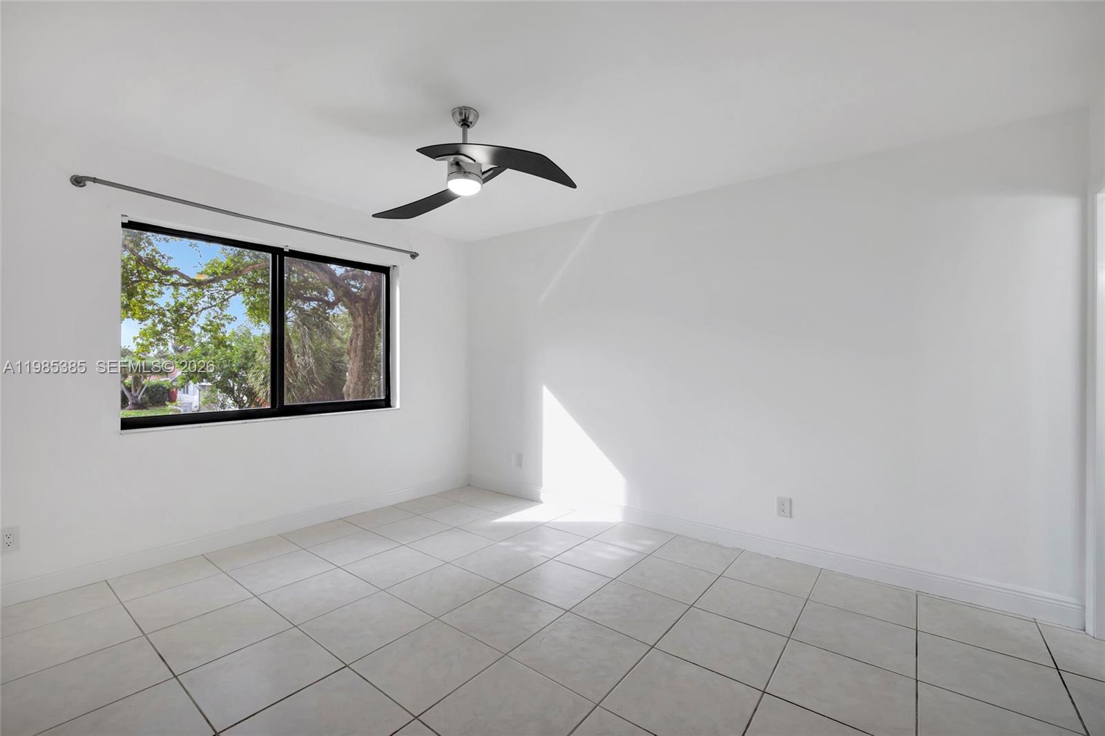 126 South Cypress Road, Unit 729 Pompano Beach, FL 33060 - Photo 3 of 26 a view of an empty room with a window