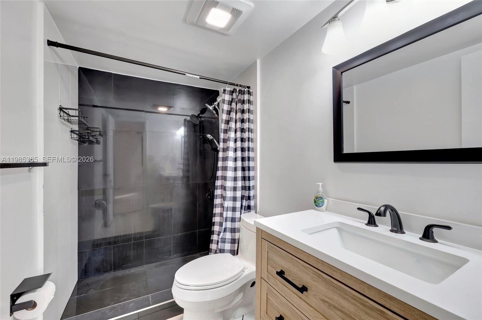 126 South Cypress Road, Unit 729 Pompano Beach, FL 33060 - Photo 6 of 26 a bathroom with a sink toilet and shower