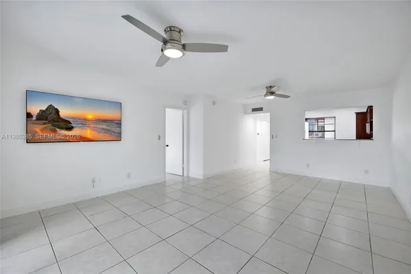 an empty room with white walls and tiles