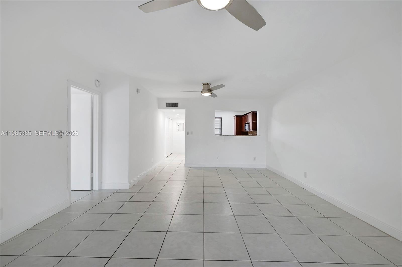 126 South Cypress Road, Unit 729 Pompano Beach, FL 33060 - Photo 8 of 26 an empty room with white walls and tiles