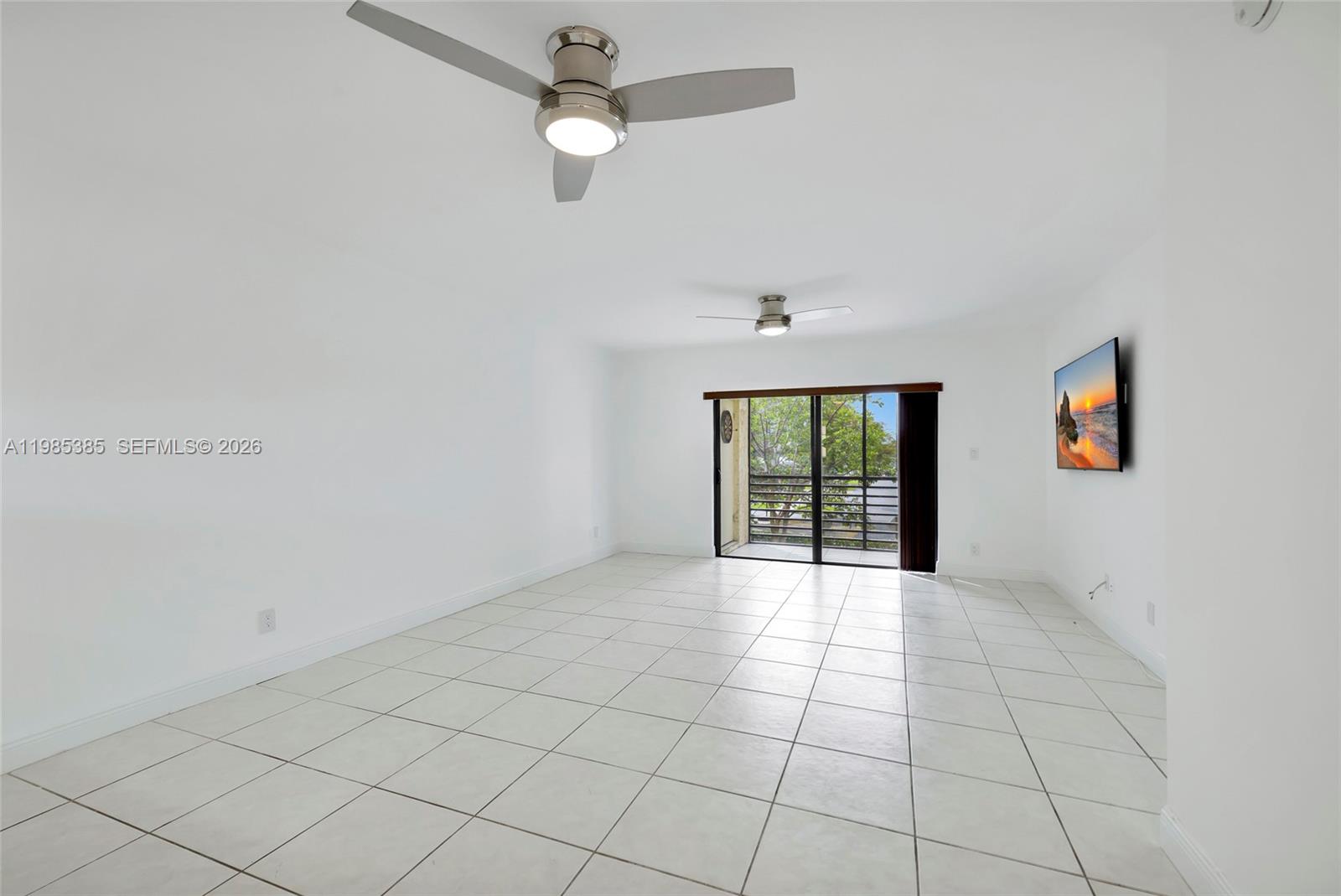 126 South Cypress Road, Unit 729 Pompano Beach, FL 33060 - Photo 10 of 26 an empty room with windows and fan