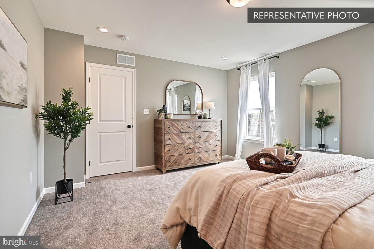 Sweet Birch Plan At Seiders Hill Pottsville, PA 17901 - Photo 13 of 15 a bedroom with a bed and a potted plant