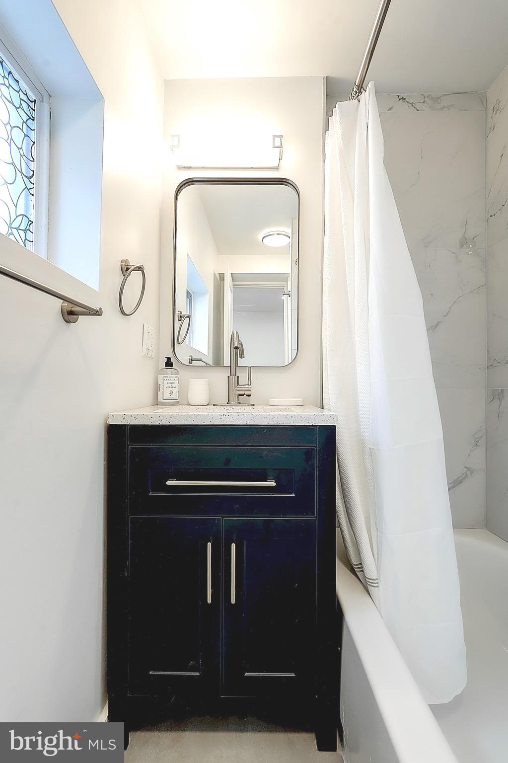 2203 Catharine Street Philadelphia, PA 19146 - Photo 11 of 27 a bathroom with a sink and a mirror