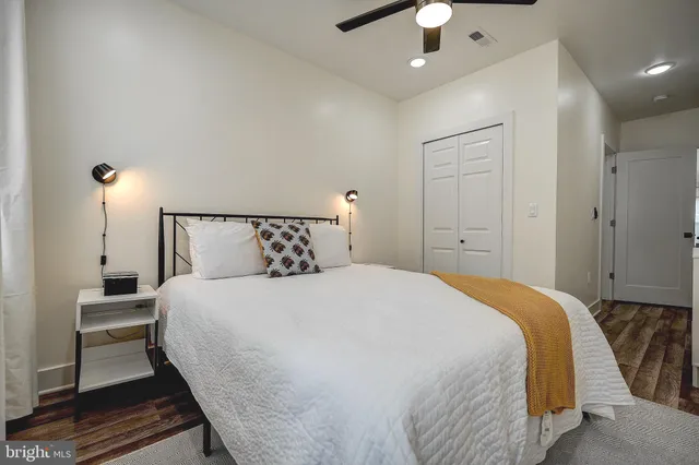 a bedroom with a bed and a lamp