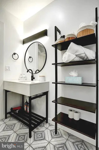 a living room with furniture and a mirror