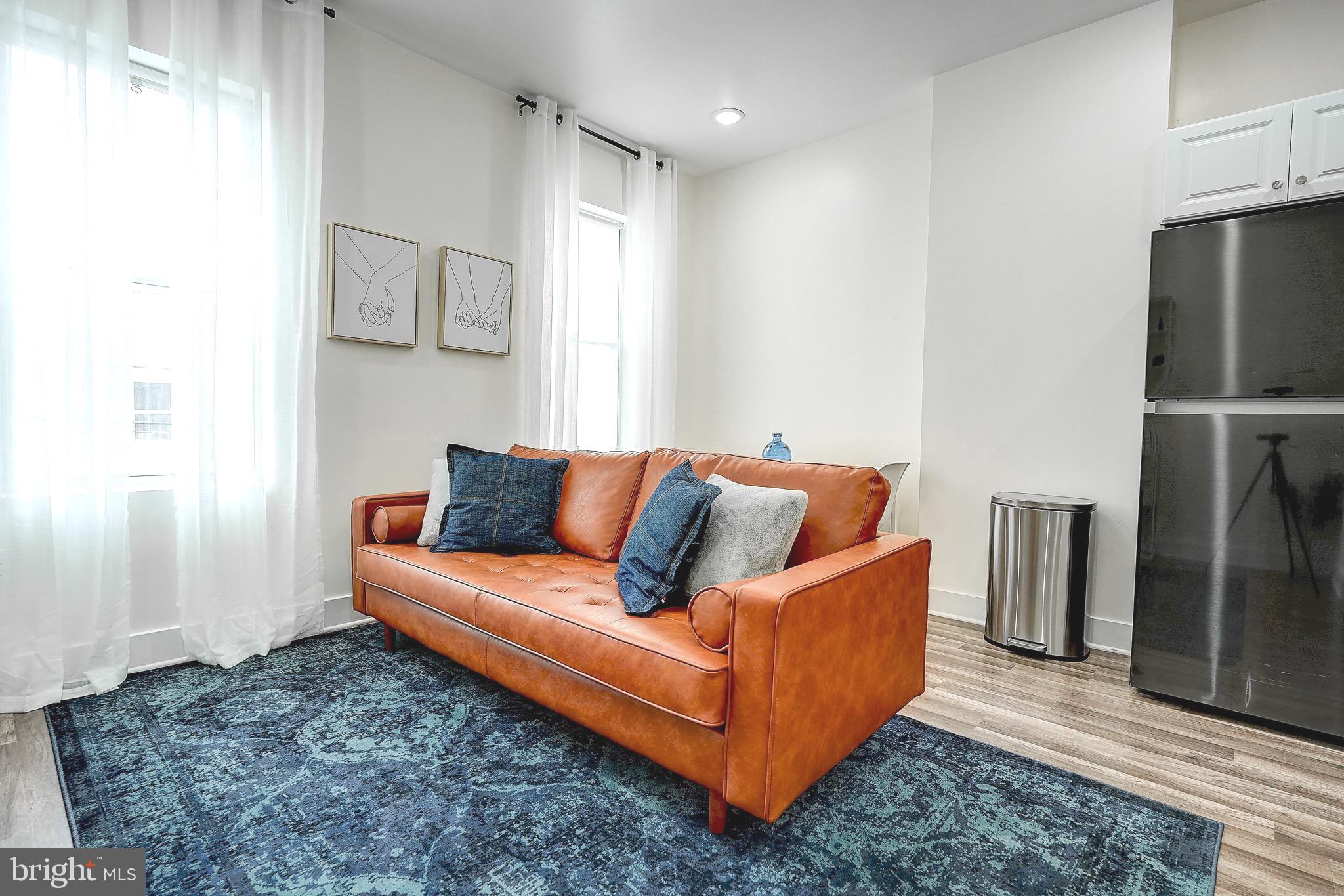 2203 Catharine Street Philadelphia, PA 19146 - Photo 23 of 27 a living room with furniture and a refrigerator
