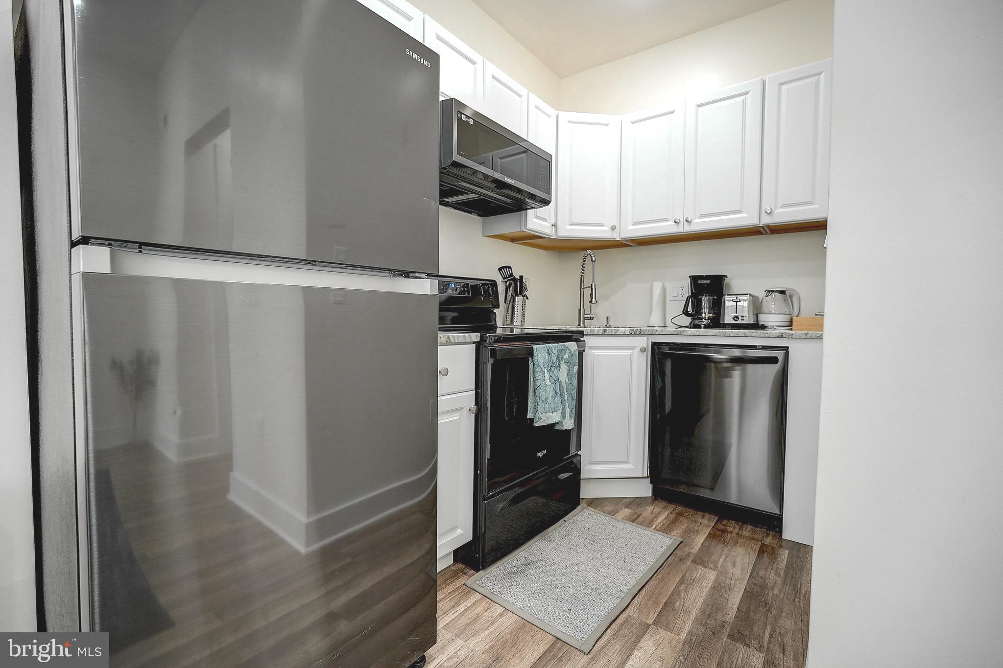 2203 Catharine Street Philadelphia, PA 19146 - Photo 25 of 27 a kitchen with stainless steel appliances granite countertop a refrigerator and a sink