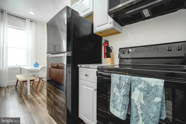 a kitchen with a refrigerator and a table
