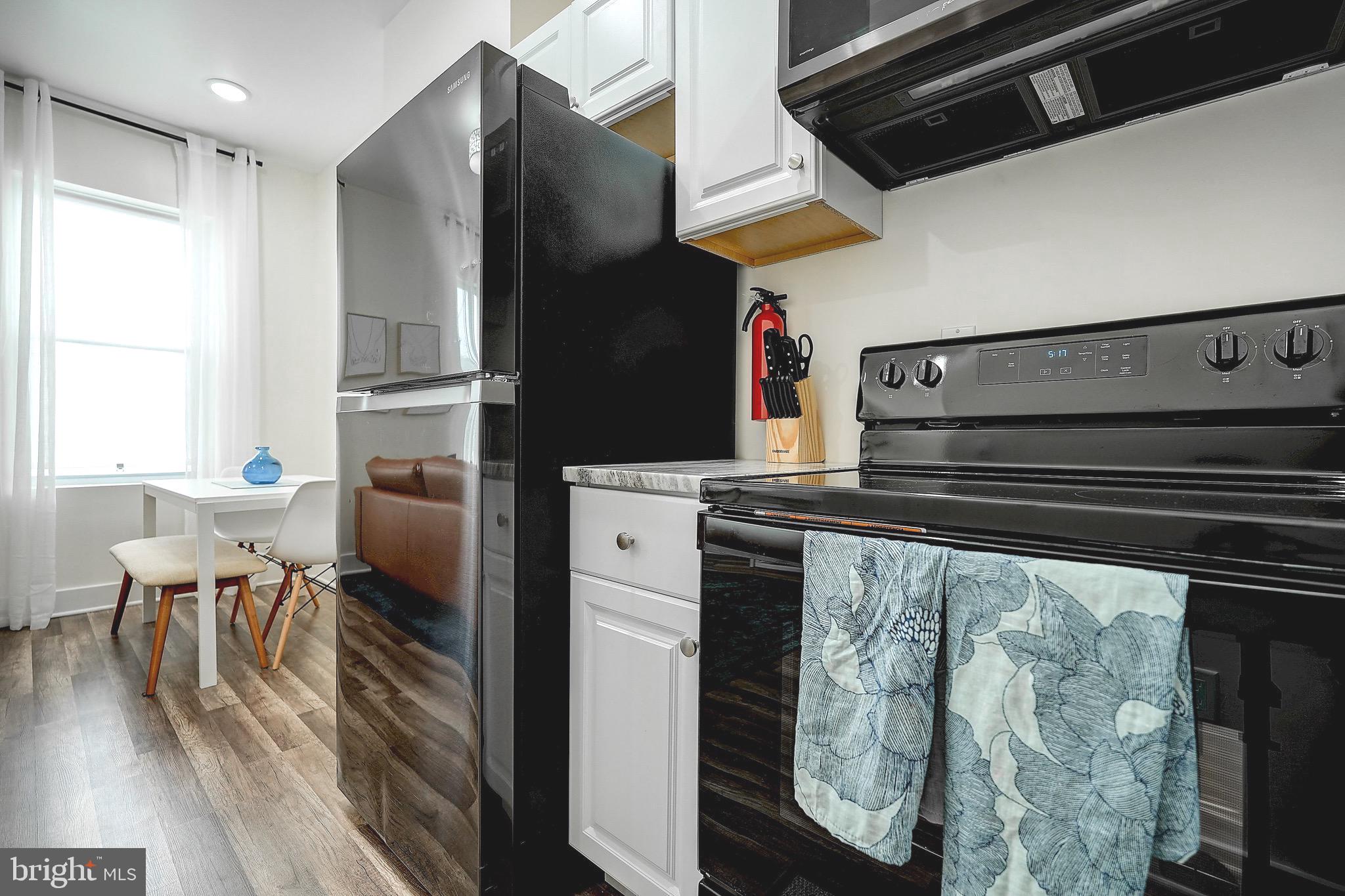 2203 Catharine Street Philadelphia, PA 19146 - Photo 26 of 27 a kitchen with a refrigerator and a table