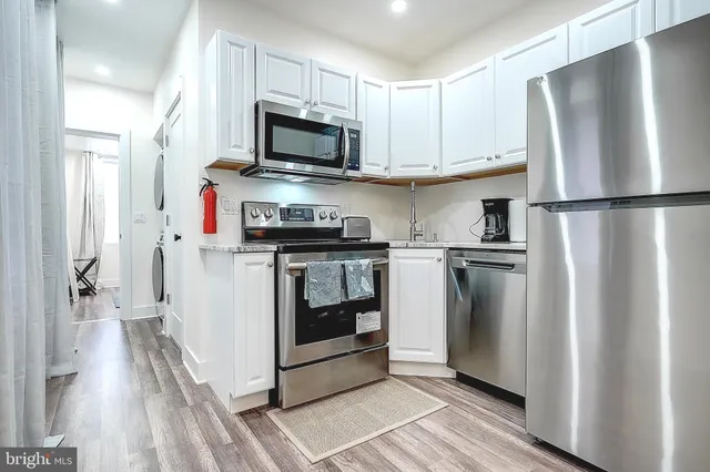 a kitchen with stainless steel appliances a refrigerator stove and microwave