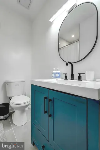 a bathroom with a sink mirror and toilet