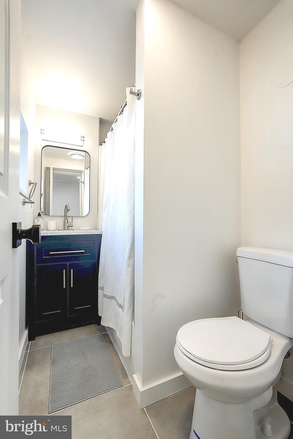 2203 Catharine Street Philadelphia, PA 19146 - Photo 10 of 27 a bathroom with a toilet a sink and mirror