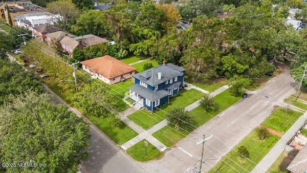 an aerial view of residential house with outdoor space and swimming pool
