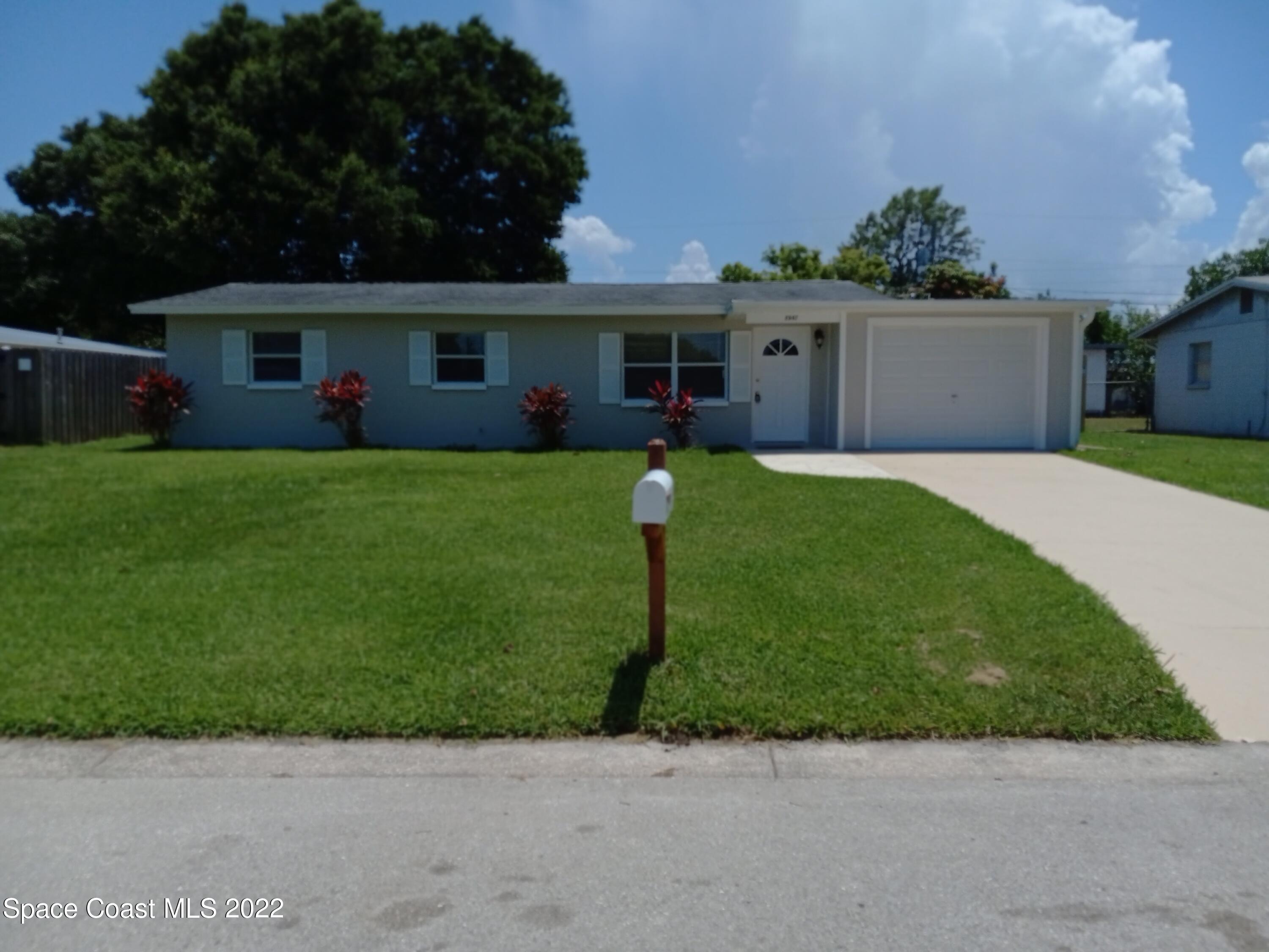 2567 Coventry Road Melbourne, FL 32935 - Photo 1 of 9 a front view of house with a yard and a garage