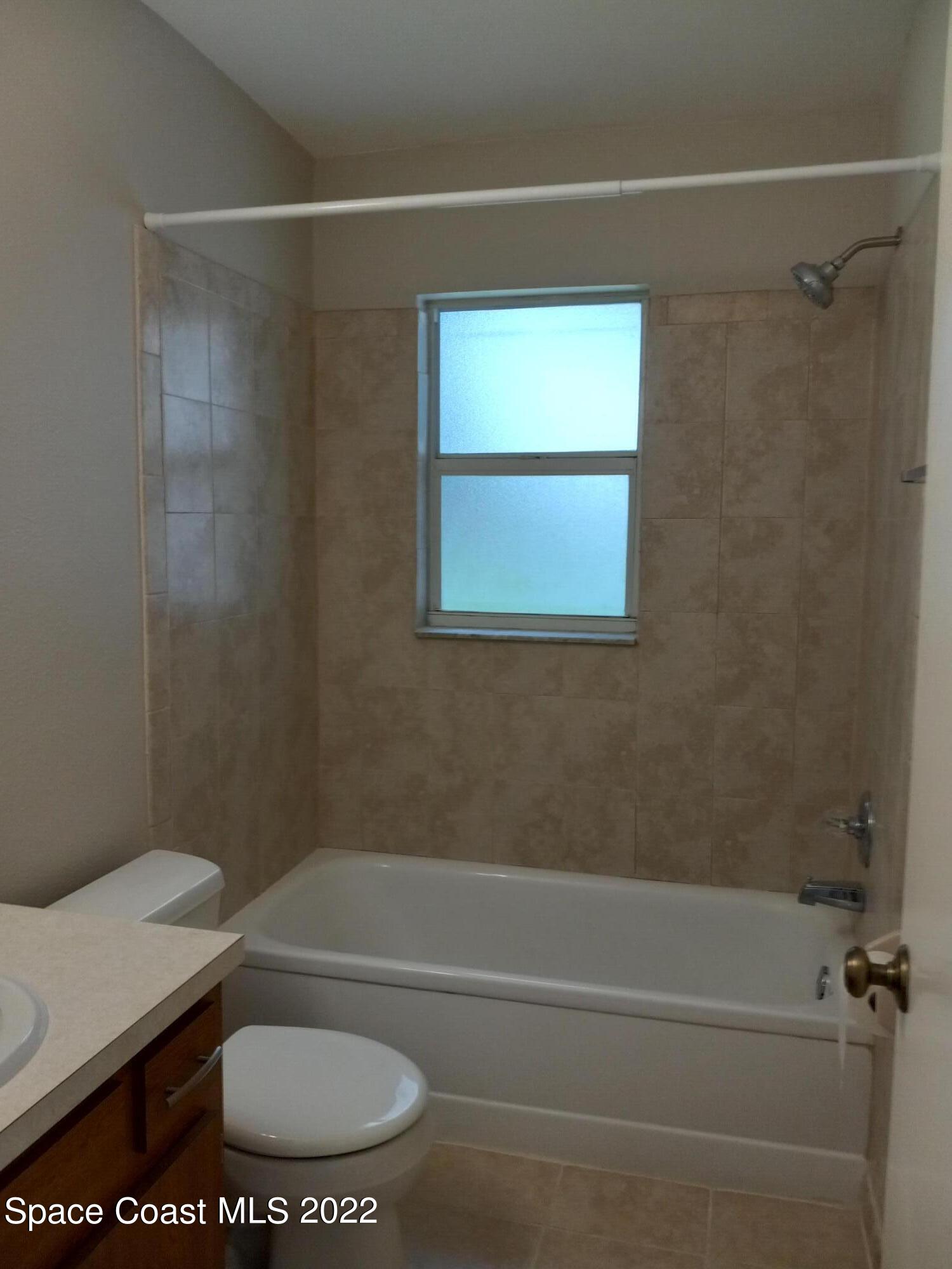 2567 Coventry Road Melbourne, FL 32935 - Photo 9 of 9 a bathroom with a toilet and a shower