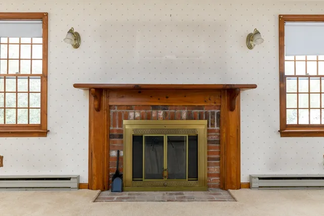 a view of a livingroom with an empty space and a fireplace