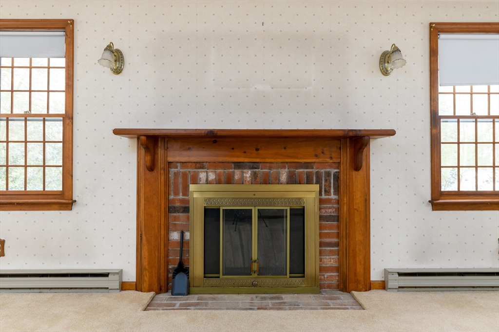 224 Podunk Road Sturbridge, MA 01566 - Photo 11 of 26 a view of a livingroom with an empty space and a fireplace