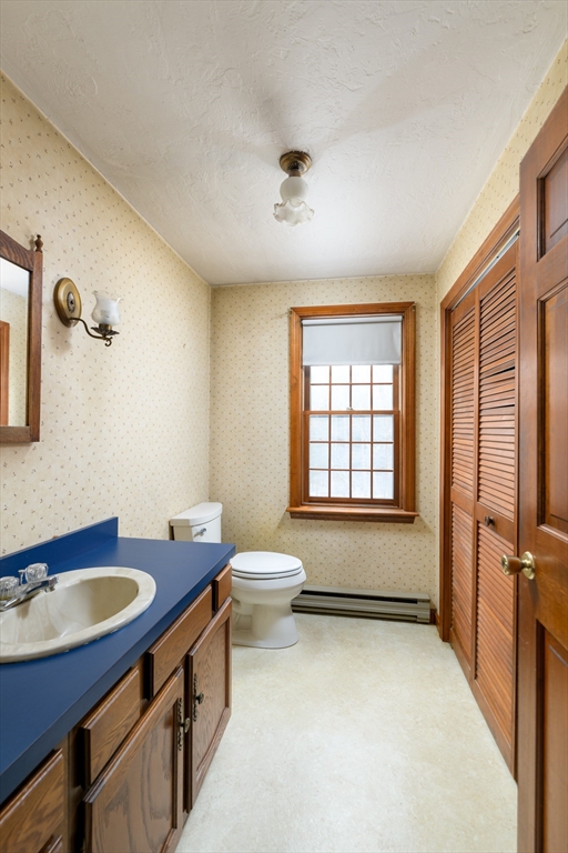 224 Podunk Road Sturbridge, MA 01566 - Photo 12 of 26 a bathroom with a sink a toilet and tub