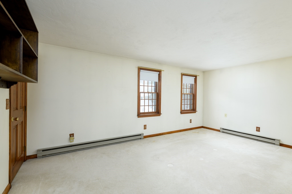 224 Podunk Road Sturbridge, MA 01566 - Photo 14 of 26 a view of an empty room with a window