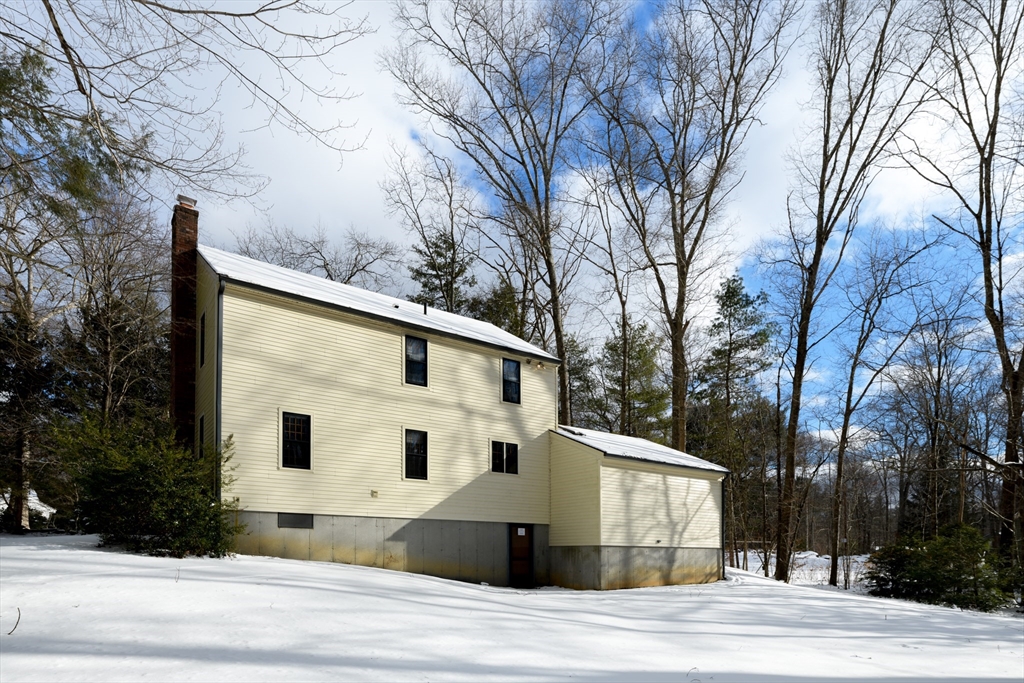224 Podunk Road Sturbridge, MA 01566 - Photo 24 of 26 a view of a house with a yard covered in snow