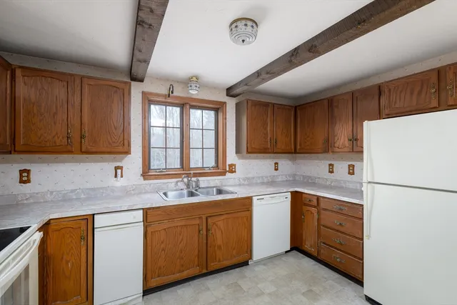 a kitchen with white cabinets sink and white appliances