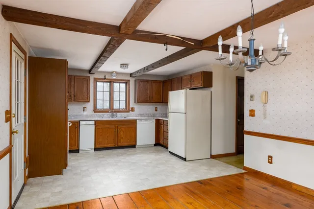 a view of a kitchen with refrigerator and microwave