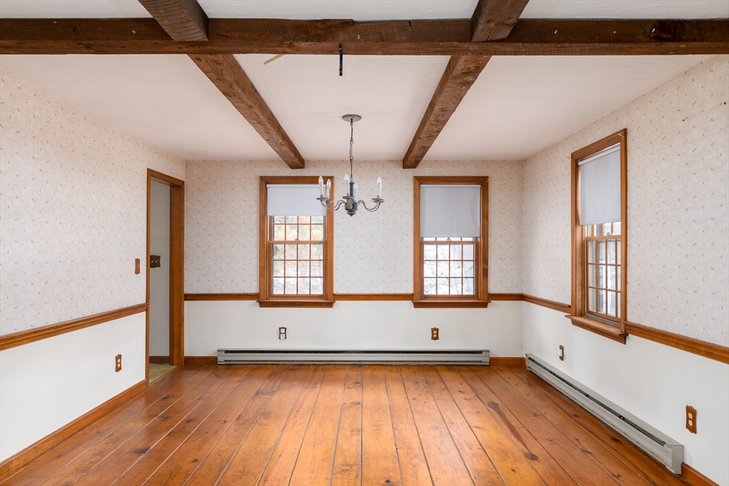 224 Podunk Road Sturbridge, MA 01566 - Photo 7 of 26 a view of an empty room with wooden floor and a window