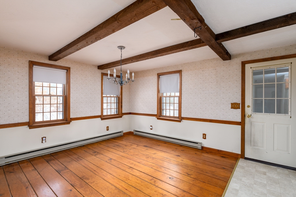 224 Podunk Road Sturbridge, MA 01566 - Photo 8 of 26 an empty room with wooden floor and windows