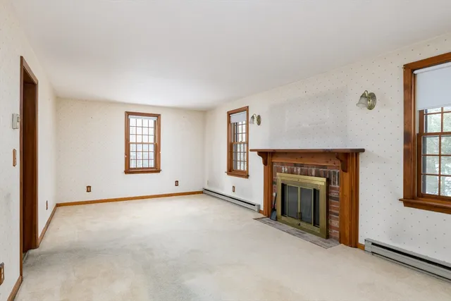 a view of empty room with a fireplace