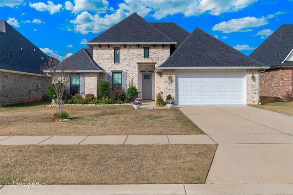 a front view of a house with a yard and a garage