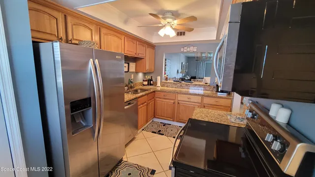 a kitchen with stainless steel appliances a stove a sink and a refrigerator
