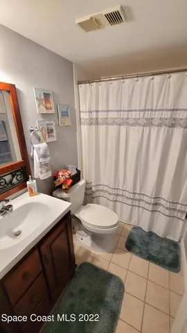 a bedroom with a bed couch and a window