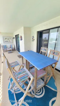 a view of a balcony with chairs